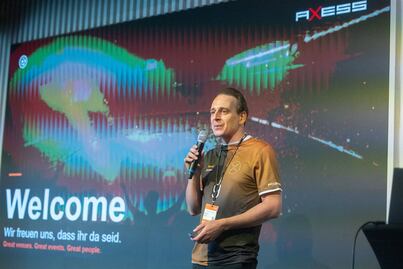 Christian Heidegger welcomes the guests on stage at the Axess Tech Summit 2026