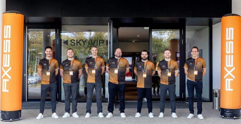 The Axess team at the Sky VIP entrance of Red Bull Arena Salzburg, flanked by orange Axess pillars